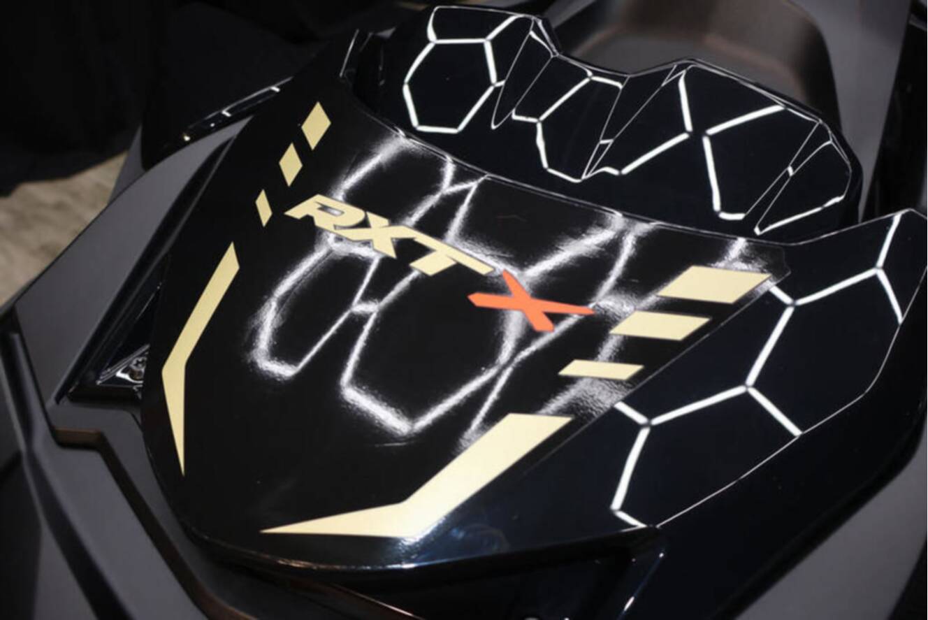 A photo of this 2025 Sea-Doo RXP-X 325 iBR Metallic Tan / Lava Red Premium