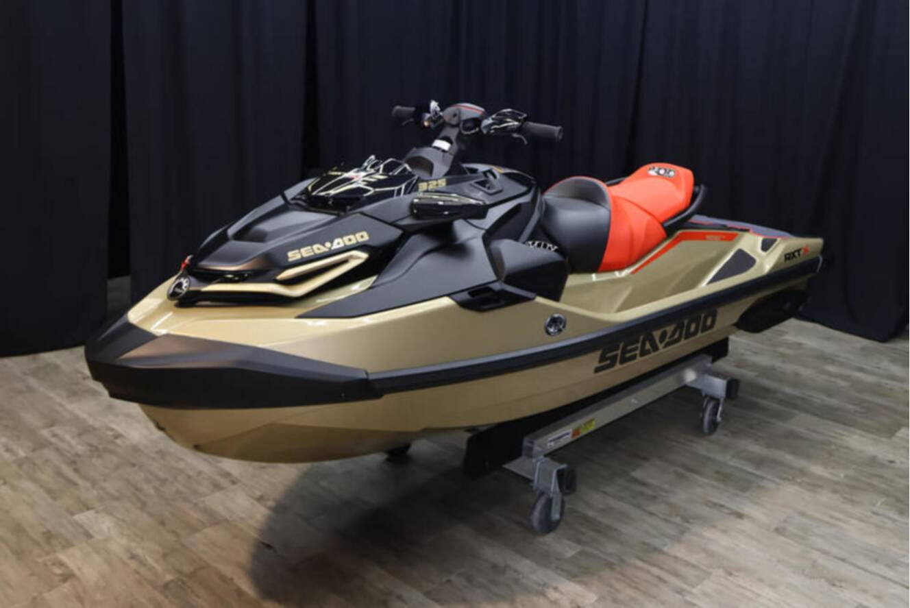 A photo of this 2025 Sea-Doo RXP-X 325 iBR Metallic Tan / Lava Red Premium