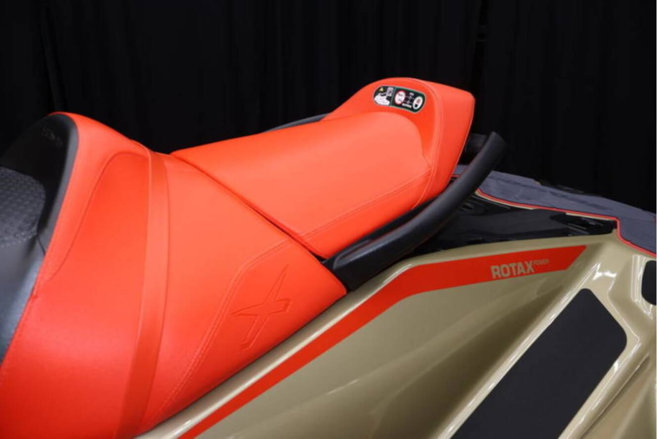 A photo of this 2025 Sea-Doo RXP-X 325 iBR Metallic Tan / Lava Red Premium