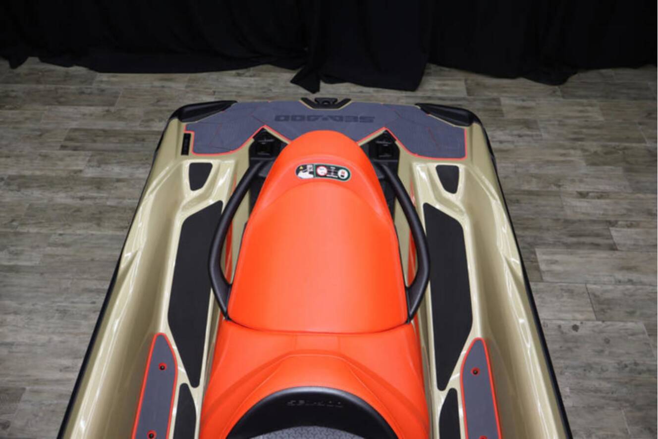 A photo of this 2025 Sea-Doo RXP-X 325 iBR Metallic Tan / Lava Red Premium