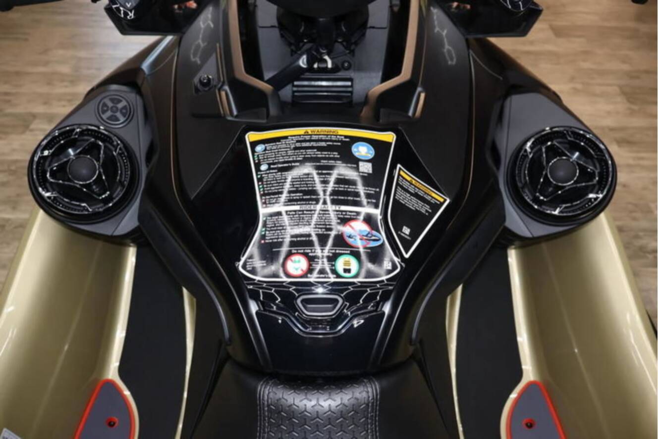 A photo of this 2025 Sea-Doo RXP-X 325 iBR Metallic Tan / Lava Red Premium