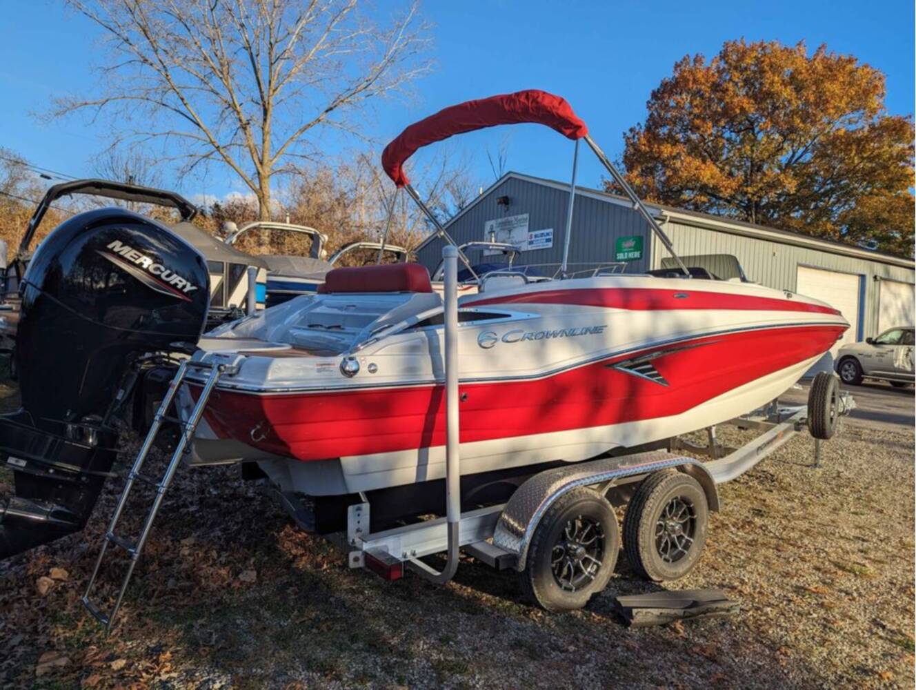 A photo of this 2025 Crownline E210 XS w/ 150 HP Mercury Outboard & Matching Trailer