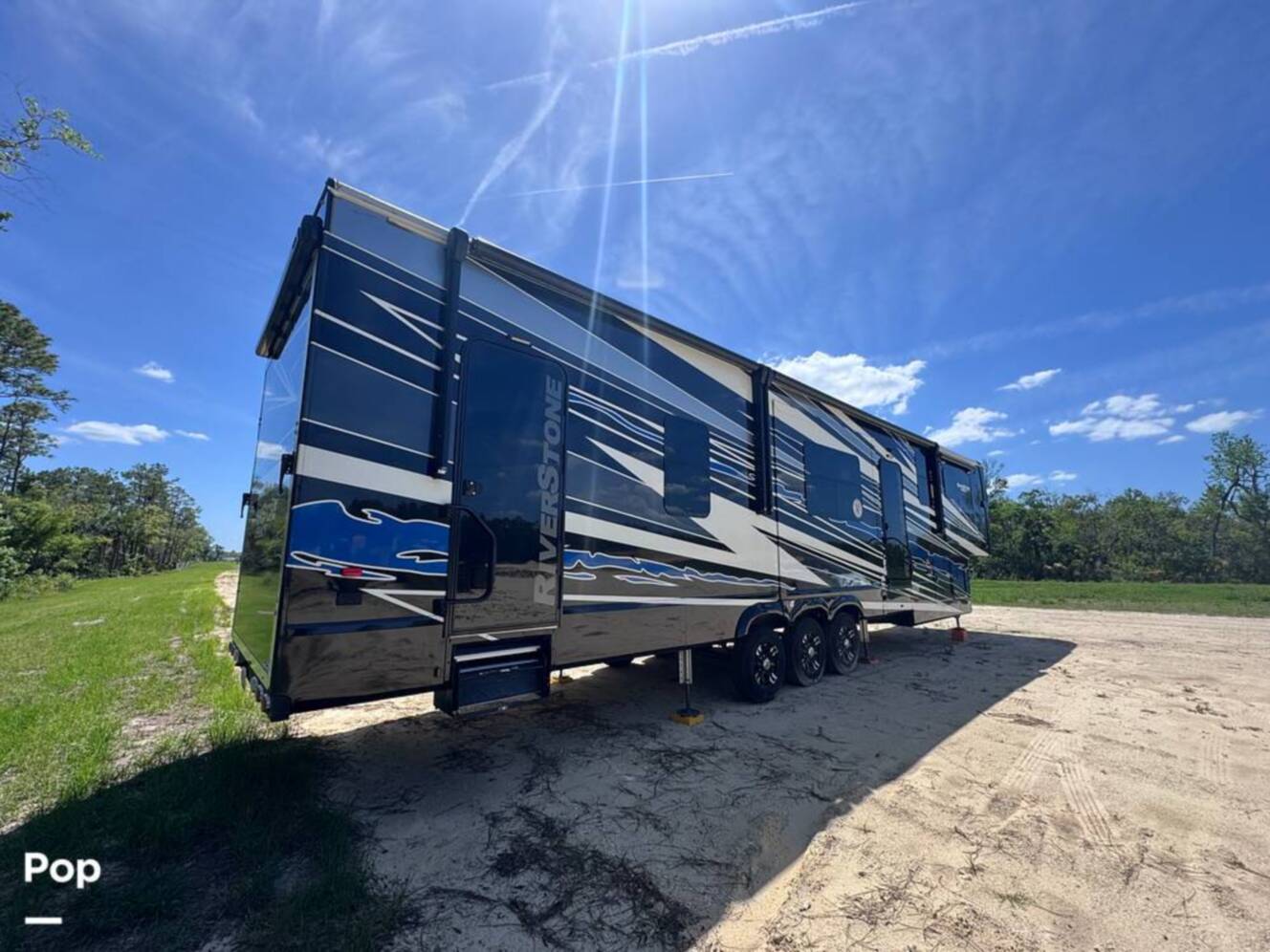 A photo of this 2023 Forest River Riverstone 45BATH Toy Hauler