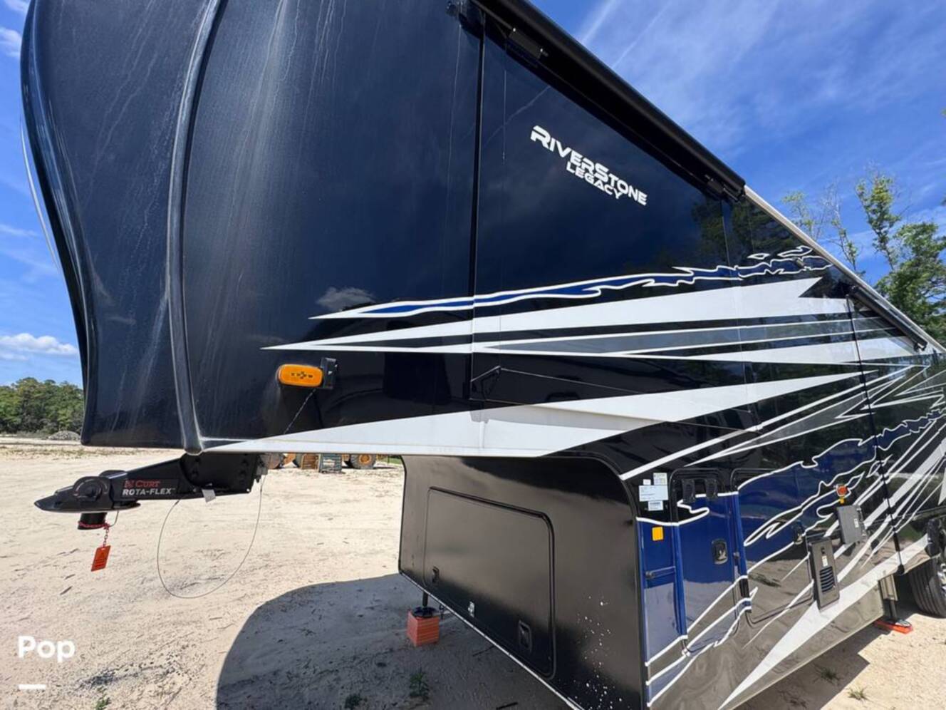 A photo of this 2023 Forest River Riverstone 45BATH Toy Hauler