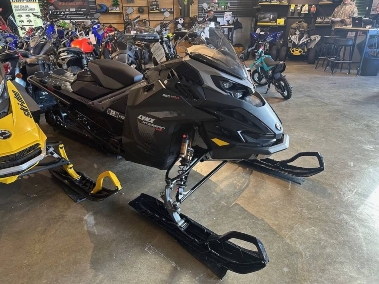 A photo of this 2026 Lynx® Xterrain RE 850 E-TEC Turbo R_10.25_Silver
