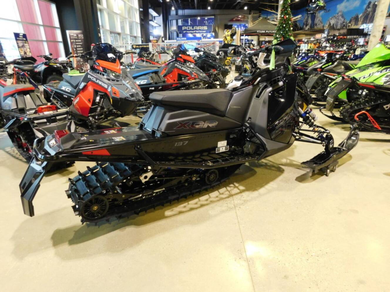 A photo of this 2026 Polaris® Patriot 9R INDY XCR 137 Gloss Black / Blue Dusk