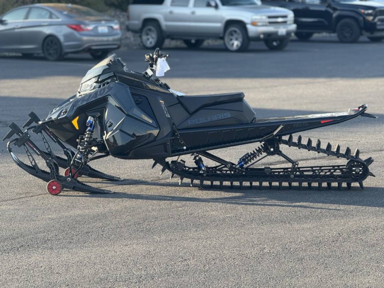 A photo of this 2026 Polaris 850 RMK Khaos 165 Gloss Black / Blue Dusk 850