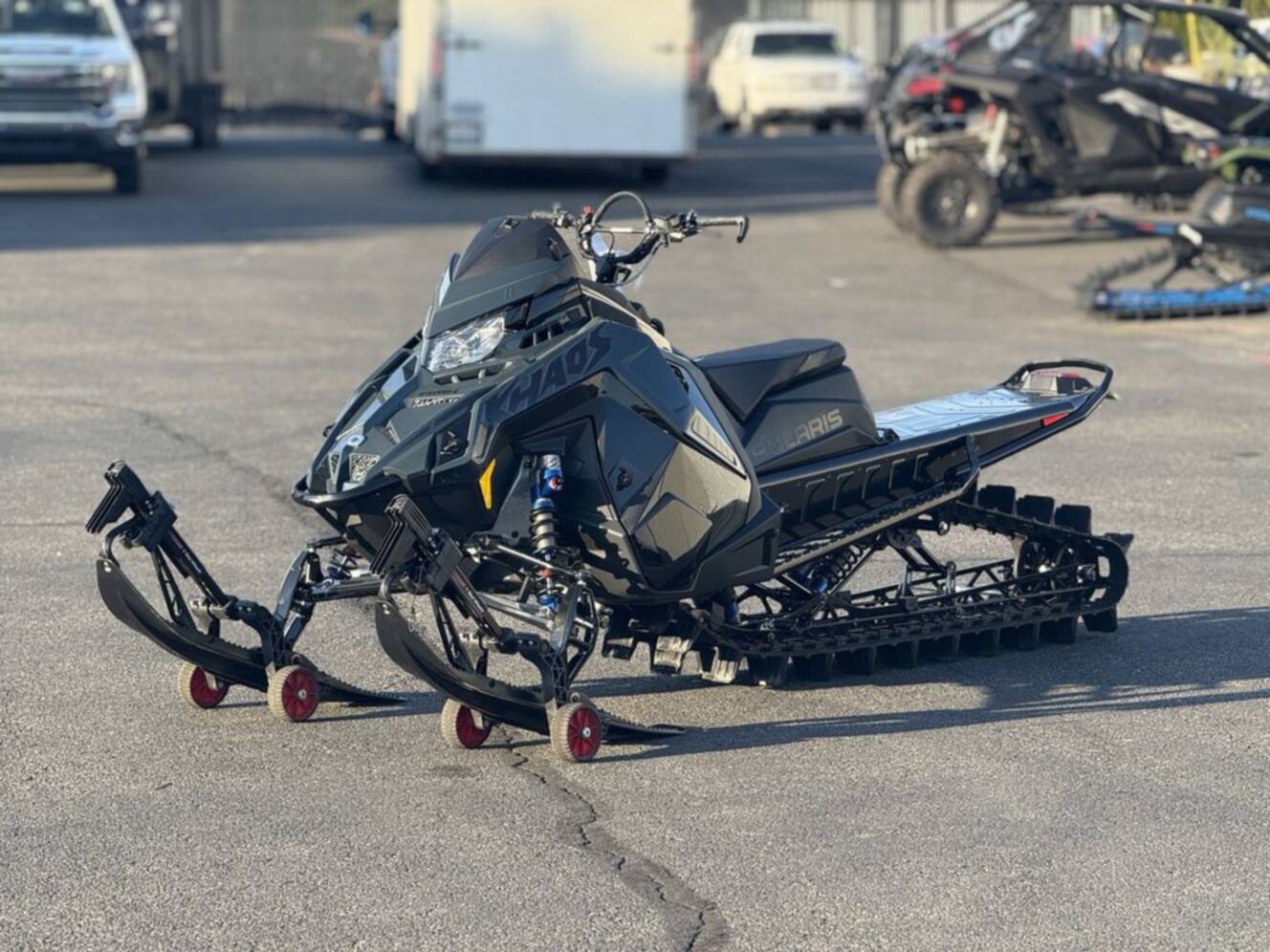 A photo of this 2026 Polaris 850 RMK Khaos 165 Gloss Black / Blue Dusk 850