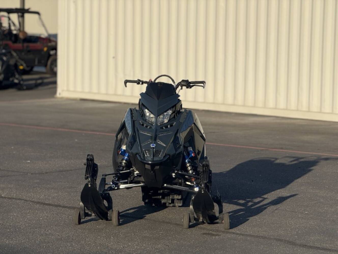 A photo of this 2026 Polaris 850 RMK Khaos 165 Gloss Black / Blue Dusk 850