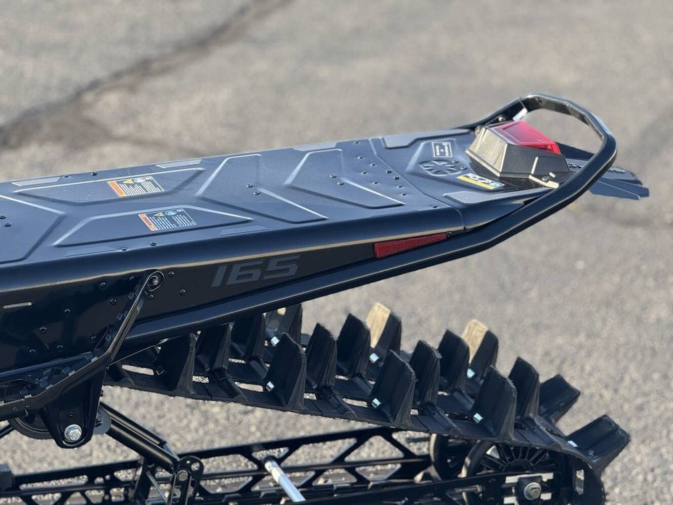 A photo of this 2026 Polaris 850 RMK Khaos 165 Gloss Black / Blue Dusk 850