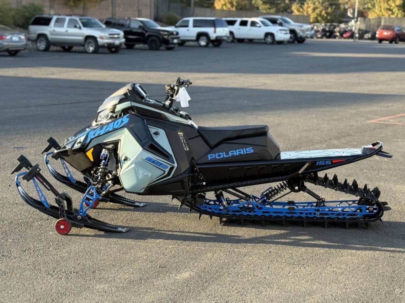 A photo of this 2026 Polaris 850 RMK Khaos 155 Gloss Black / Blue Dusk 850