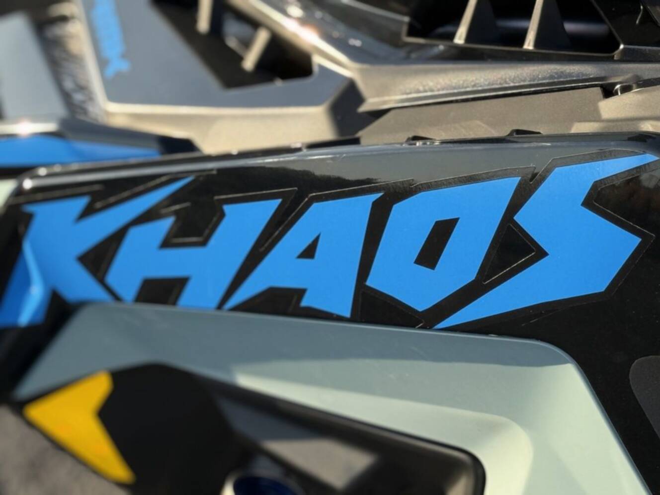 A photo of this 2026 Polaris 850 RMK Khaos 155 Gloss Black / Blue Dusk 850