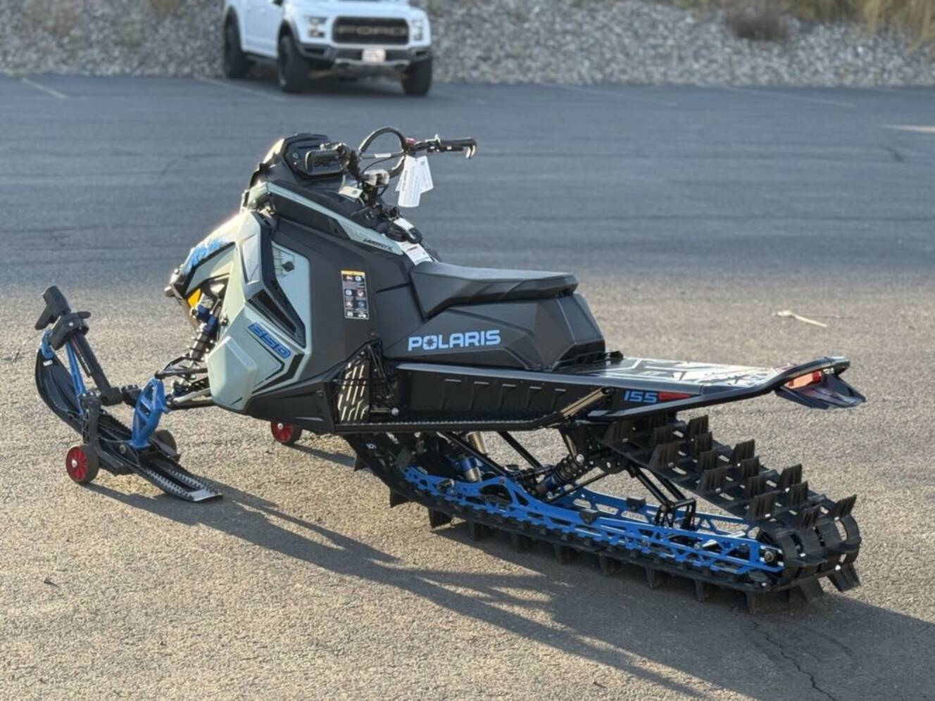 A photo of this 2026 Polaris 850 RMK Khaos 155 Gloss Black / Blue Dusk 850