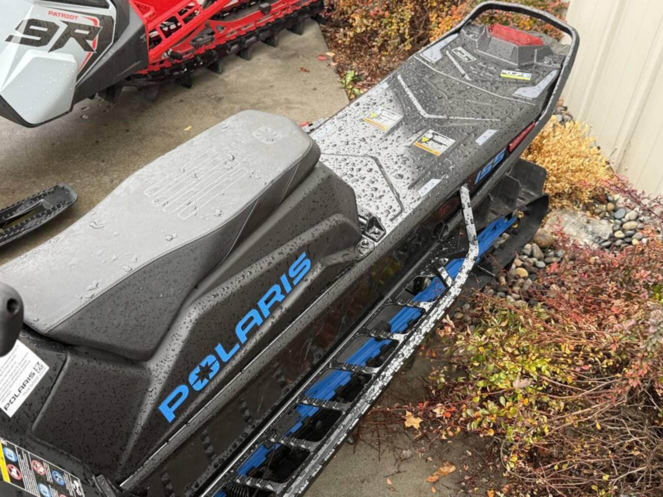 A photo of this 2026 Polaris 850 RMK Khaos 155 Gloss Black / Blue Dusk 850