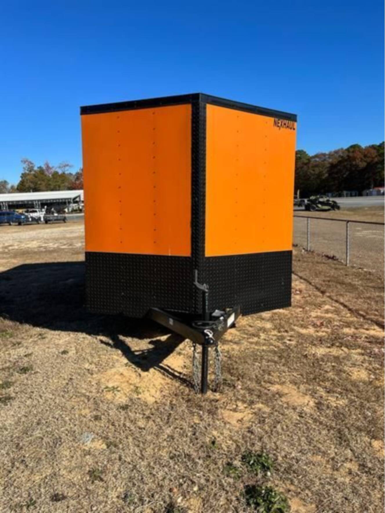 A photo of this 2023 Nexhaul Trailers 7X16 TA ORG/BLKOUT RIMS