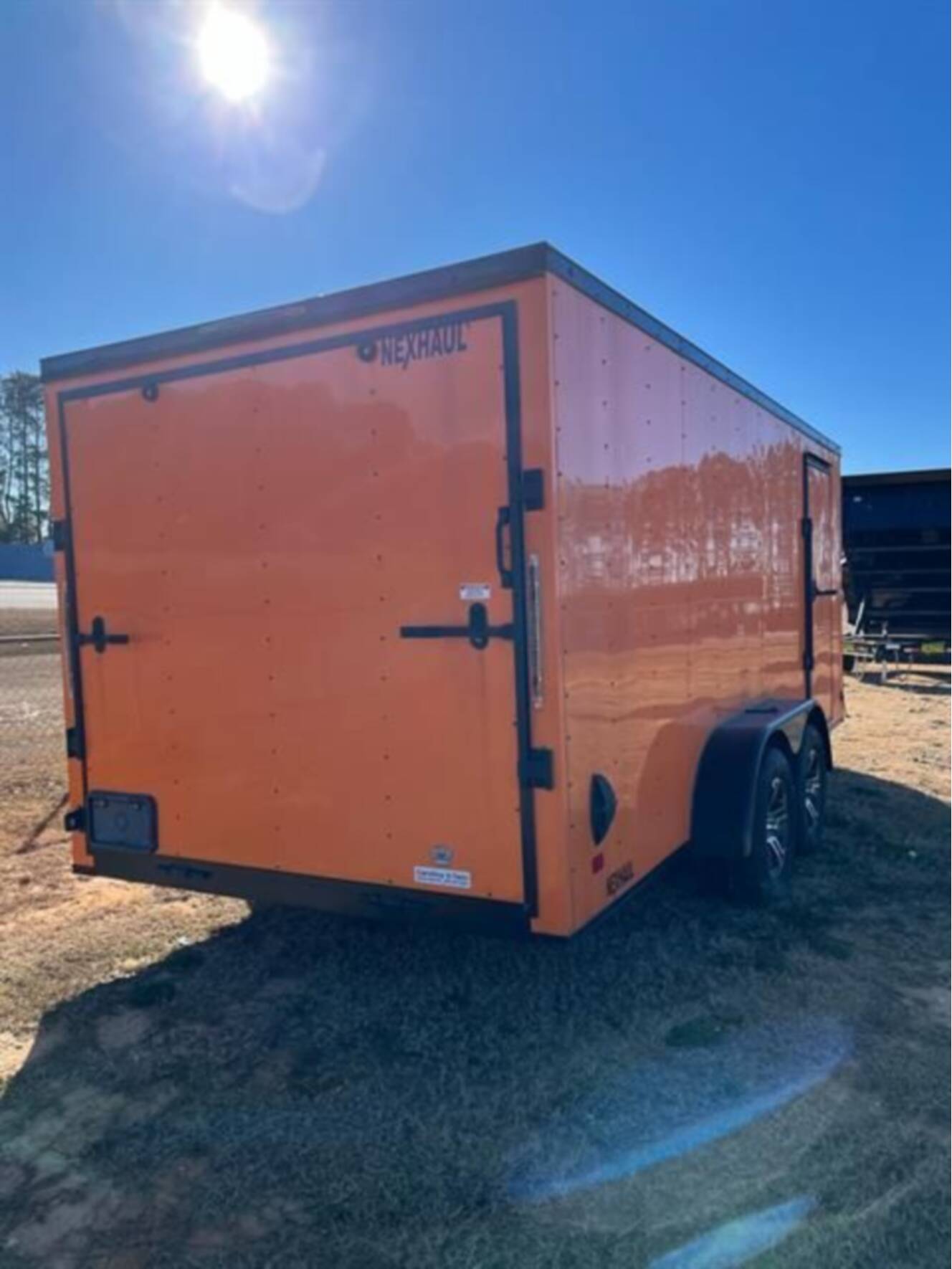 A photo of this 2023 Nexhaul Trailers 7X16 TA ORG/BLKOUT RIMS
