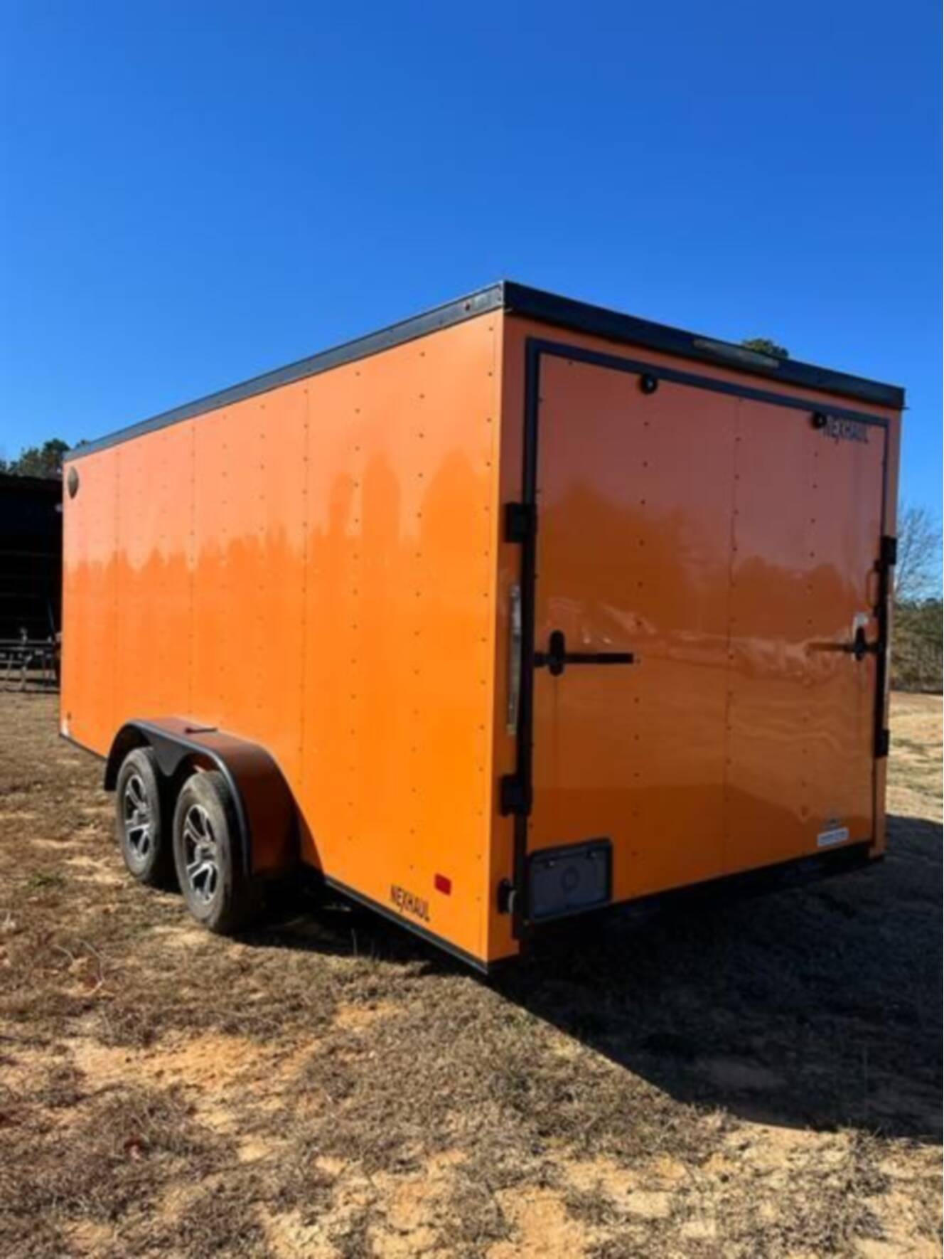 A photo of this 2023 Nexhaul Trailers 7X16 TA ORG/BLKOUT RIMS