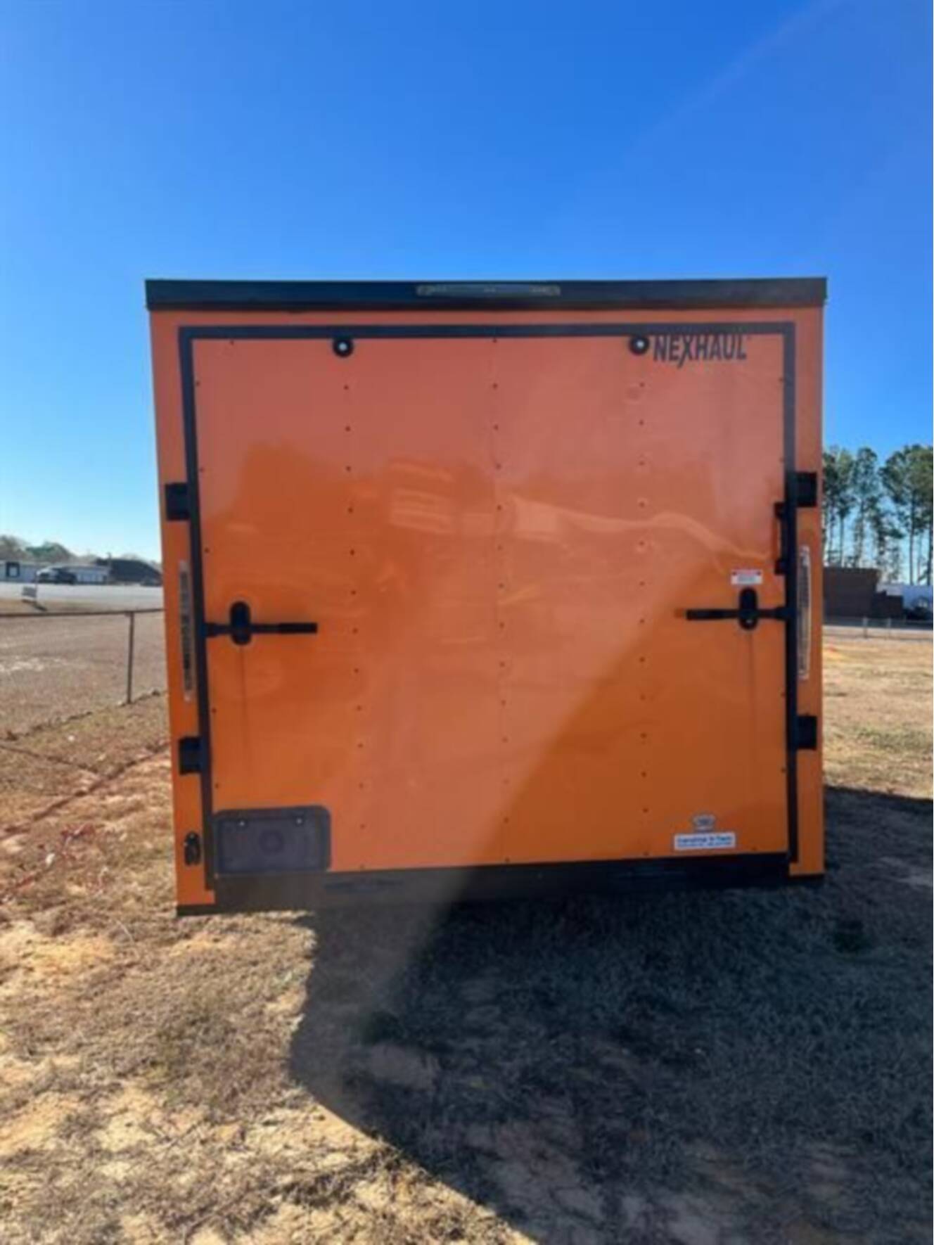 A photo of this 2023 Nexhaul Trailers 7X16 TA ORG/BLKOUT RIMS