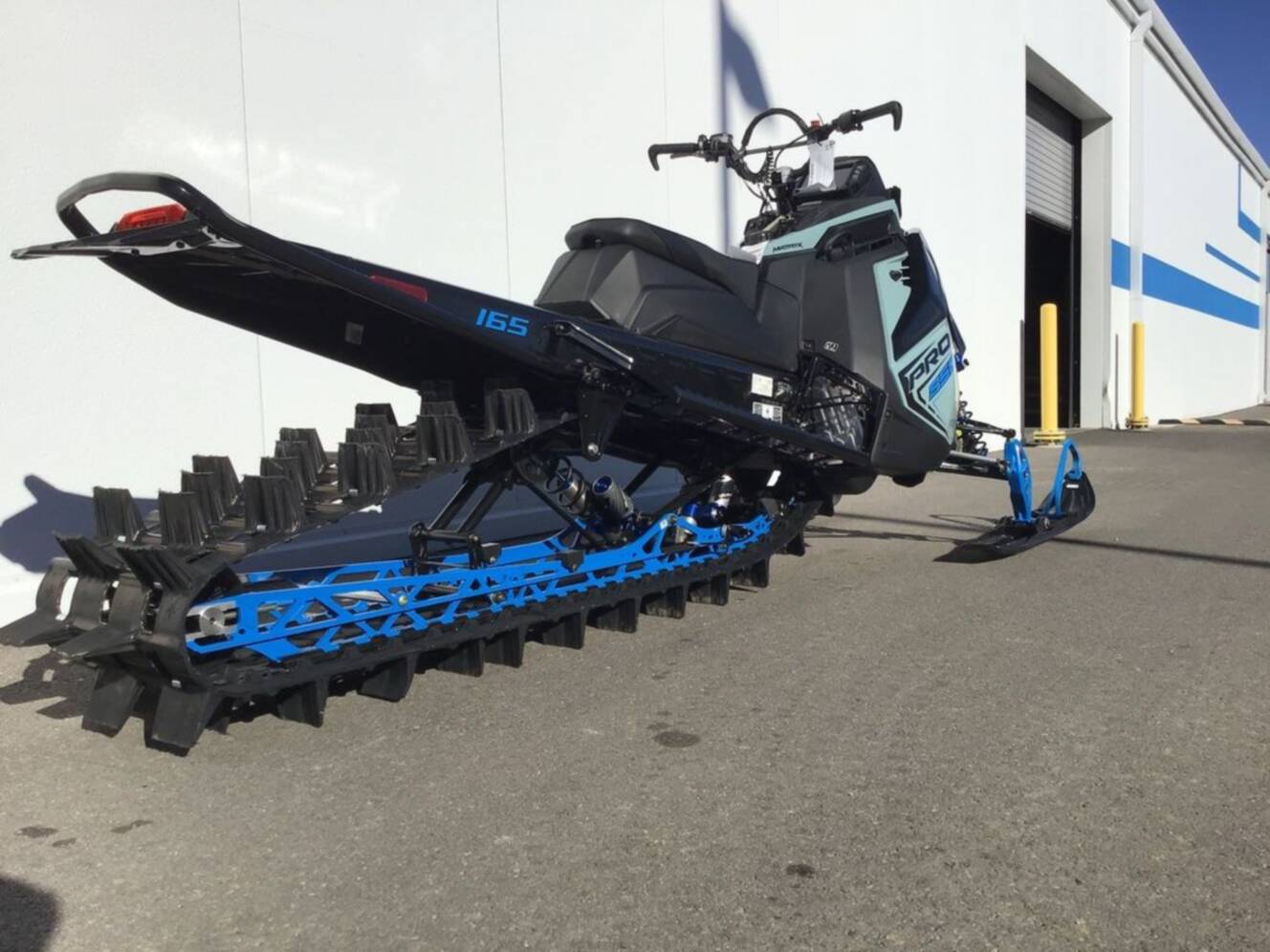 A photo of this 2026 Polaris® 850 PRO RMK 165 Hemlock Blue / Black / Velocity Blue