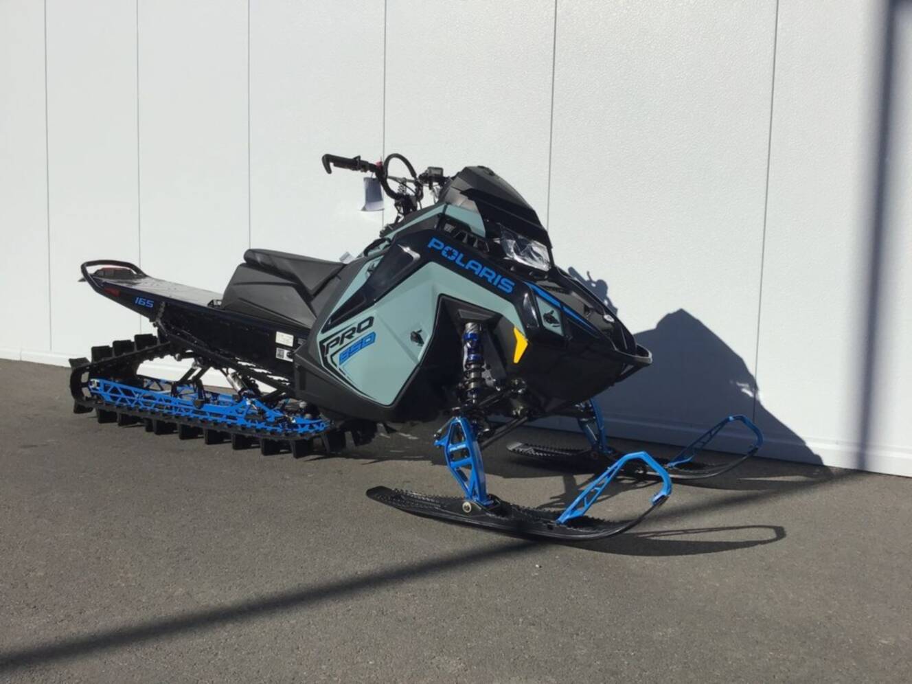 A photo of this 2026 Polaris® 850 PRO RMK 165 Hemlock Blue / Black / Velocity Blue