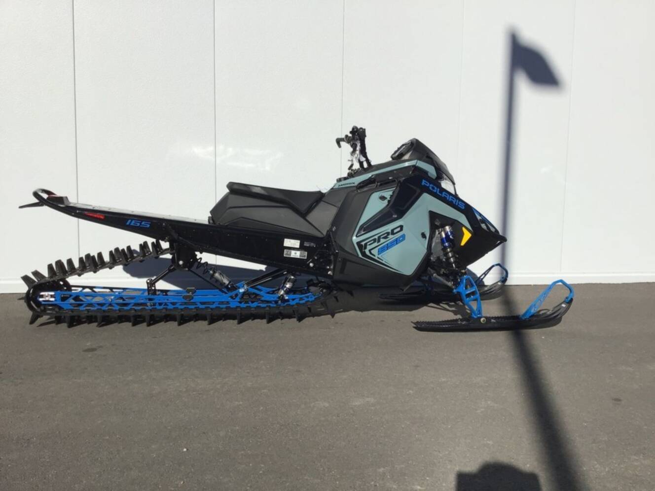 A photo of this 2026 Polaris® 850 PRO RMK 165 Hemlock Blue / Black / Velocity Blue