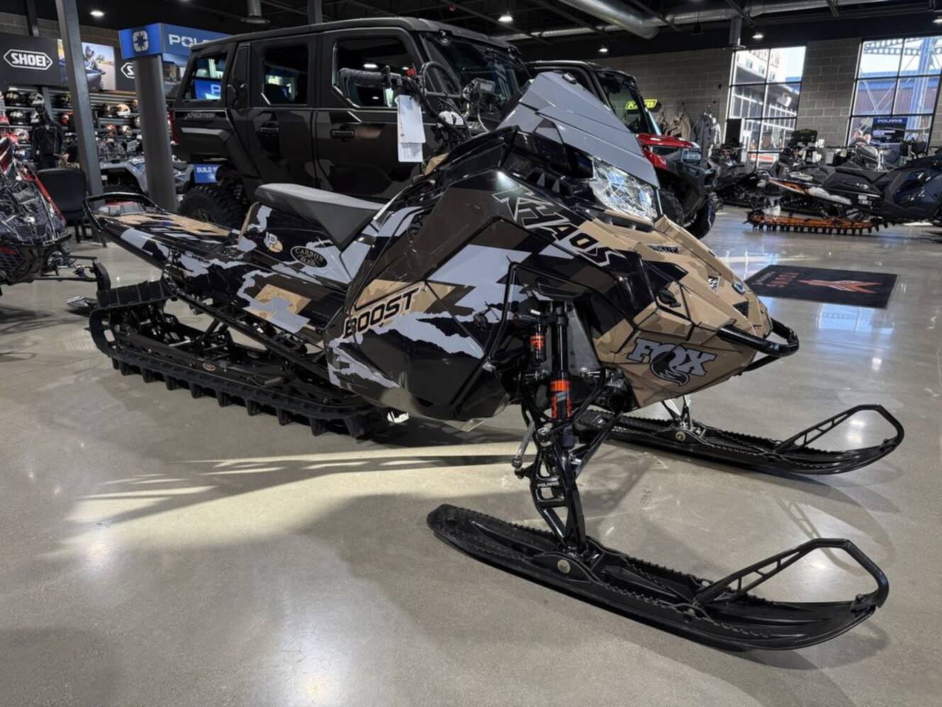 A photo of this 2026 Polaris Patriot Boost RMK Khaos 165 Gloss Black / Blue Dusk