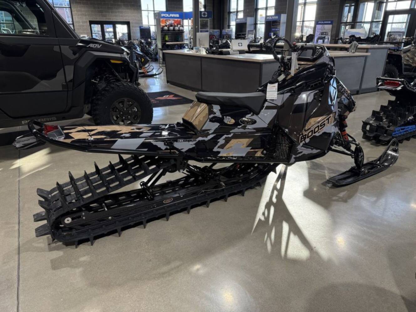 A photo of this 2026 Polaris Patriot Boost RMK Khaos 165 Gloss Black / Blue Dusk