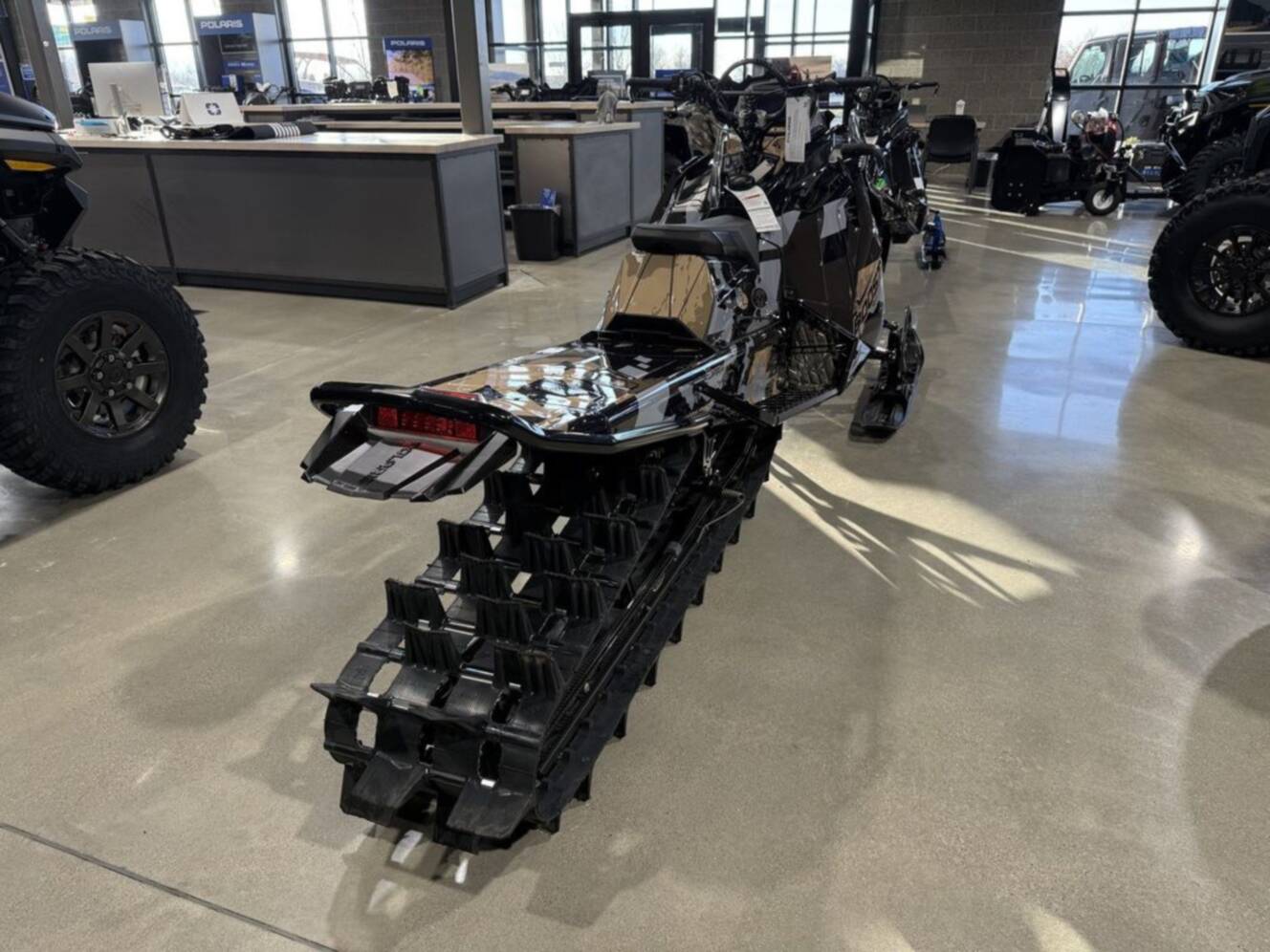 A photo of this 2026 Polaris Patriot Boost RMK Khaos 165 Gloss Black / Blue Dusk