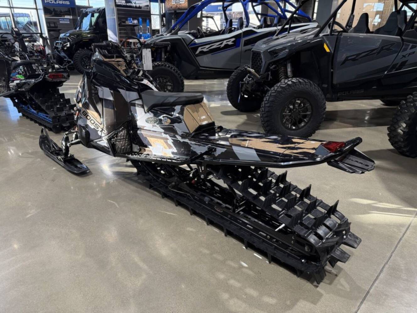 A photo of this 2026 Polaris Patriot Boost RMK Khaos 165 Gloss Black / Blue Dusk