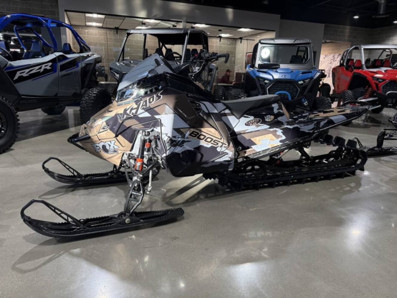 A photo of this 2026 Polaris Patriot Boost RMK Khaos 165 Gloss Black / Blue Dusk