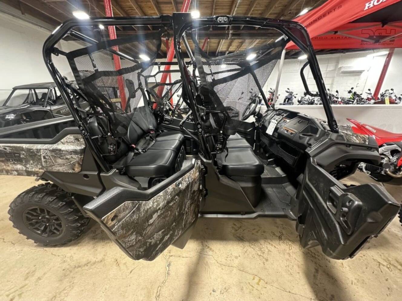 A photo of this 2025 Honda® Pioneer 1000-6 Deluxe Crew TrueTimber Atera Camo