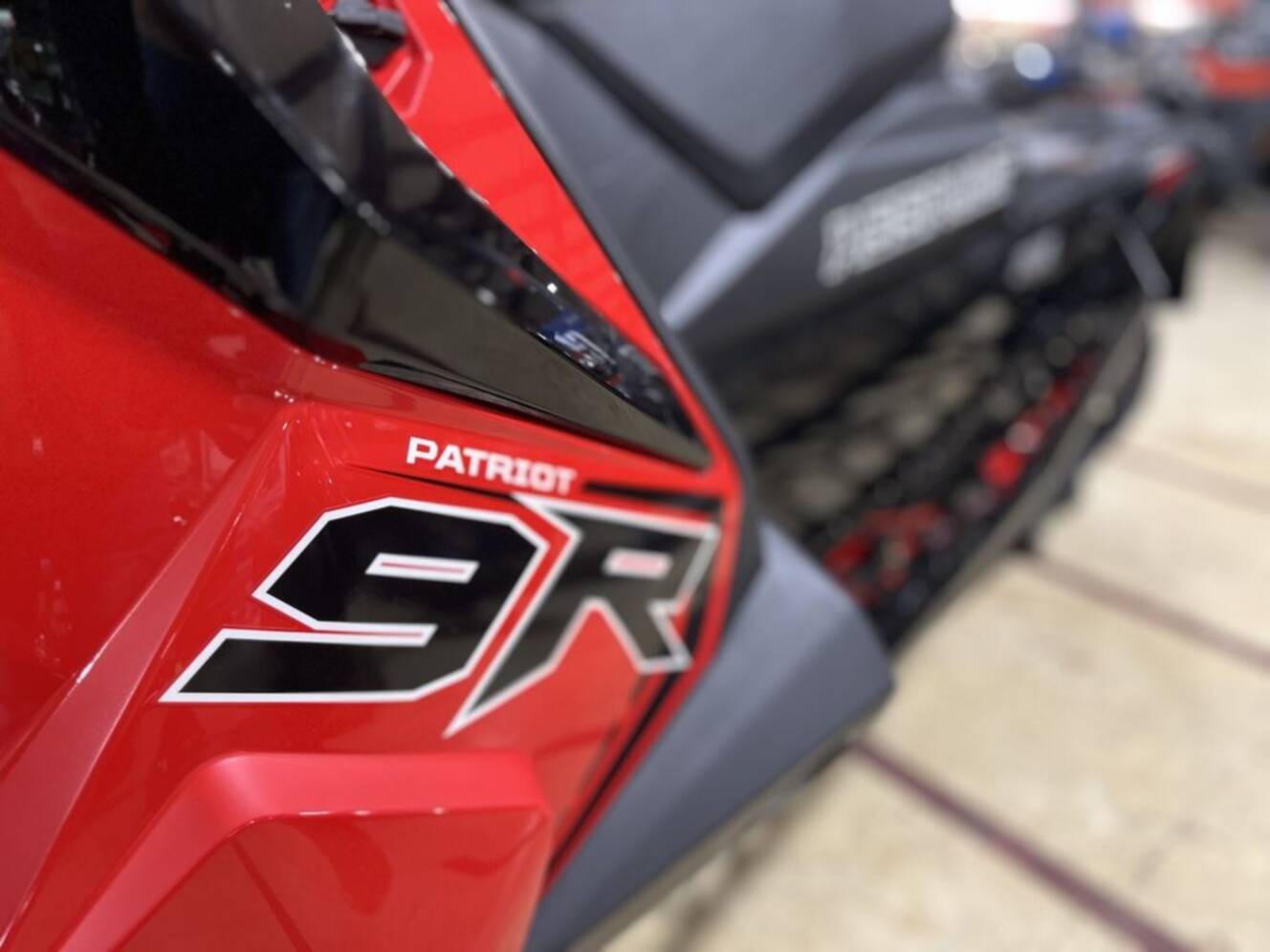 A photo of this 2026 Polaris® Patriot 9R Switchback Assault 146 - Race IFS Indy Red /
