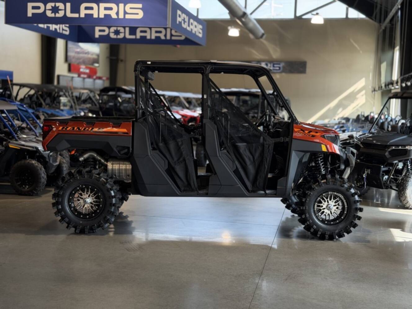 A photo of this 2026 Polaris RGR CREW XP 1000 PREMIUM ORANGE RUST