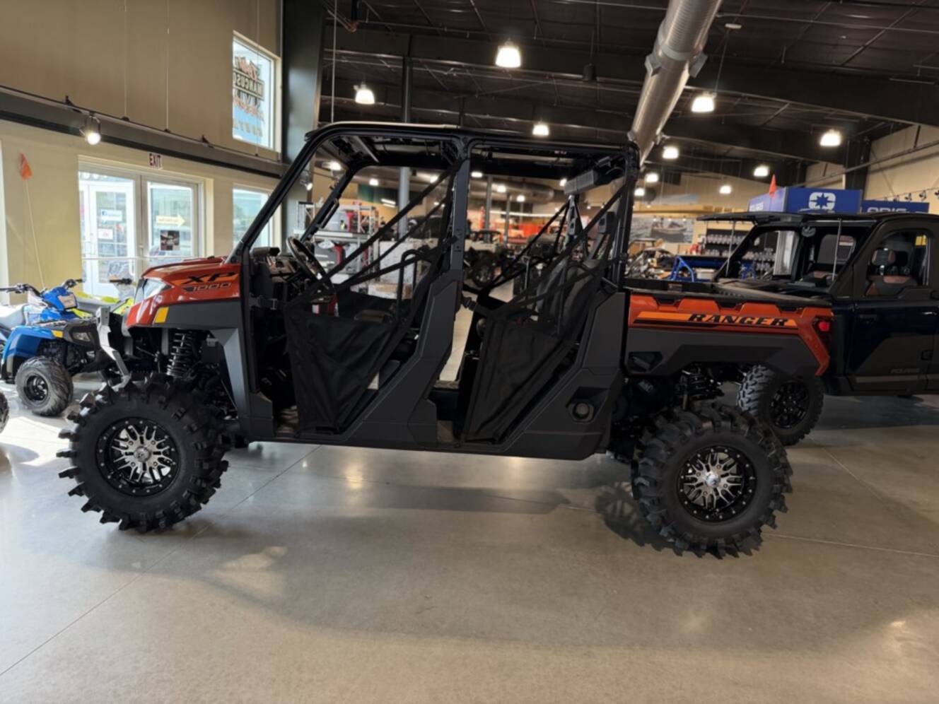 A photo of this 2026 Polaris RGR CREW XP 1000 PREMIUM ORANGE RUST