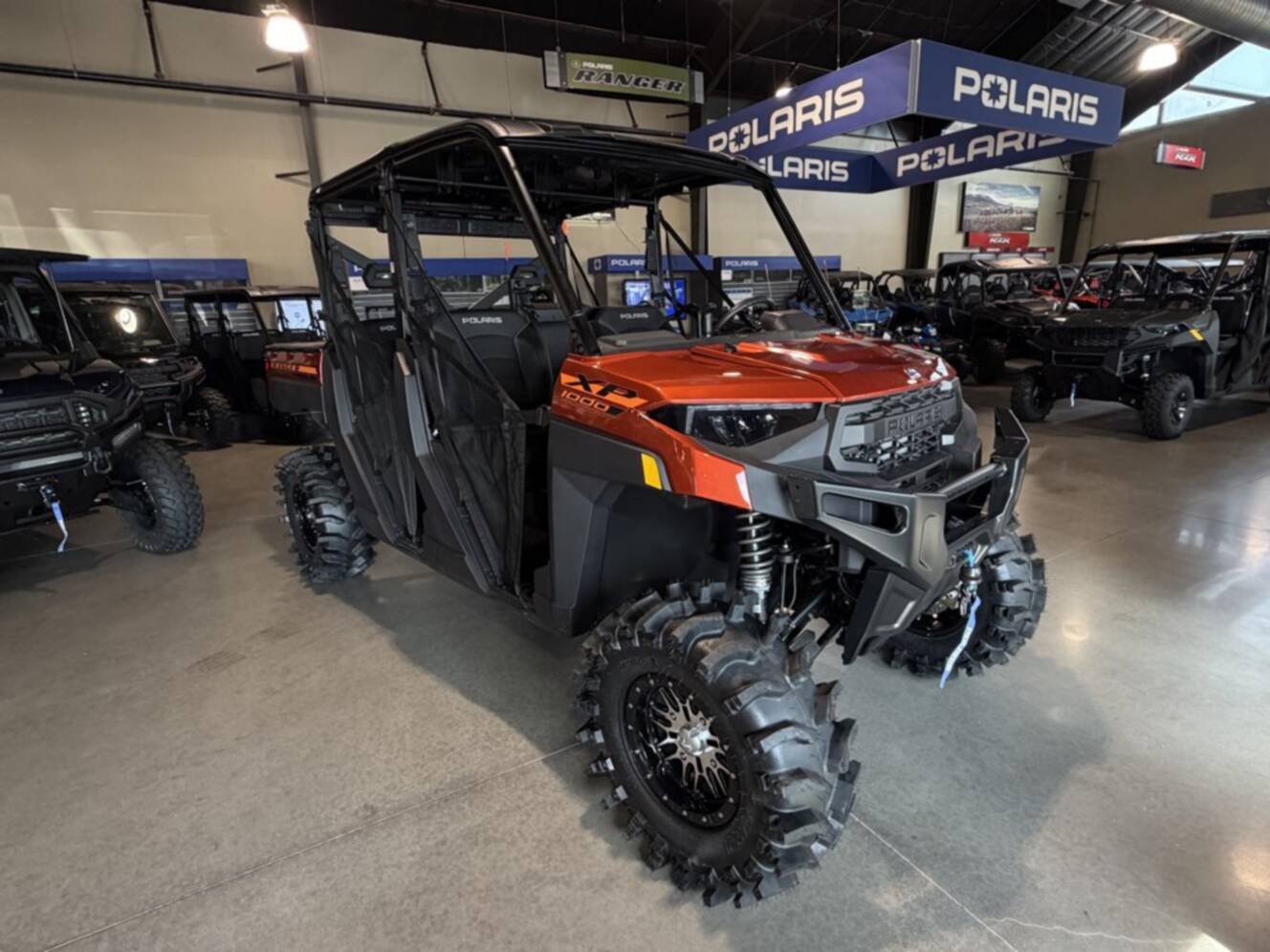 A photo of this 2026 Polaris RGR CREW XP 1000 PREMIUM ORANGE RUST