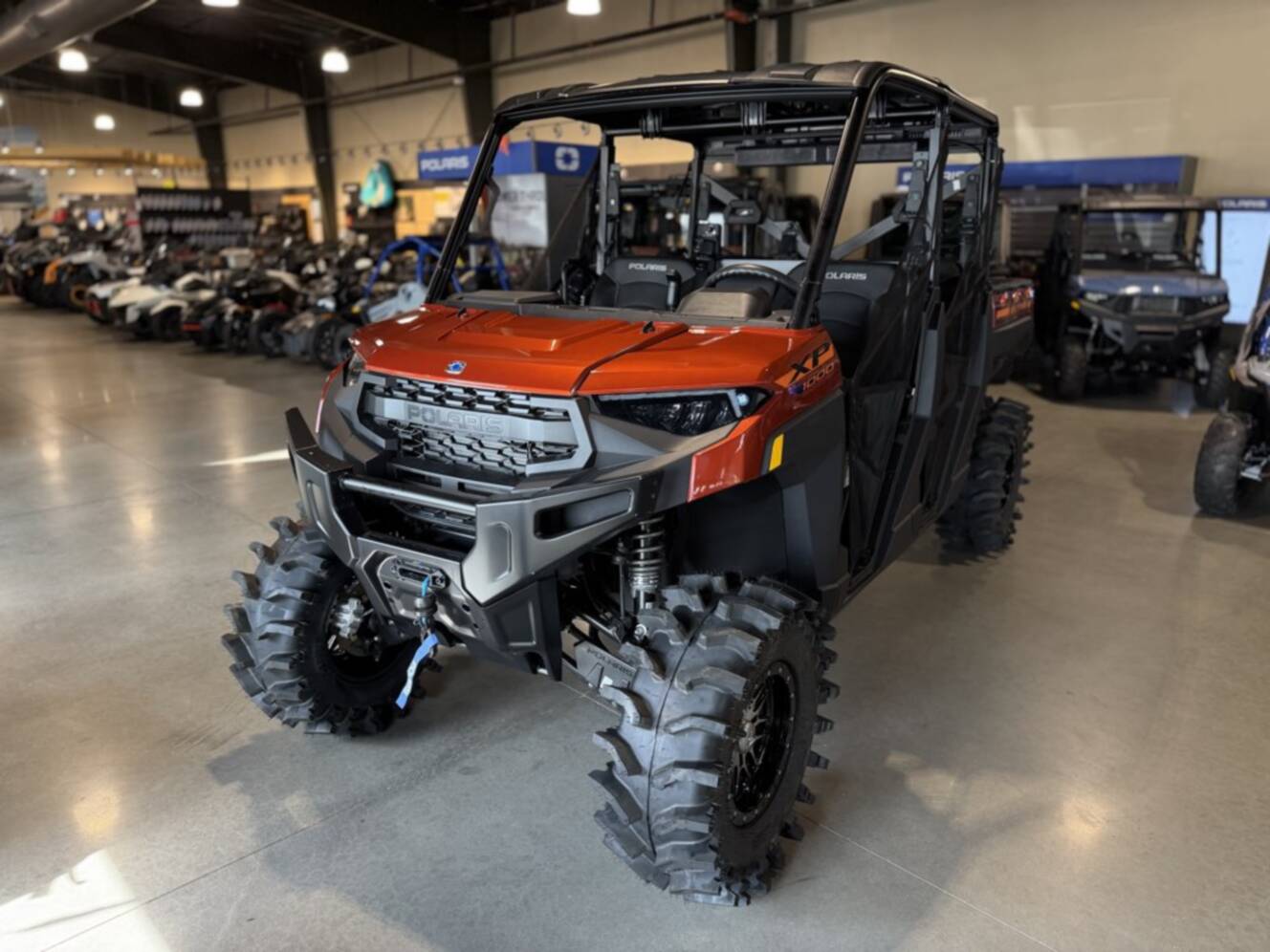 A photo of this 2026 Polaris RGR CREW XP 1000 PREMIUM ORANGE RUST