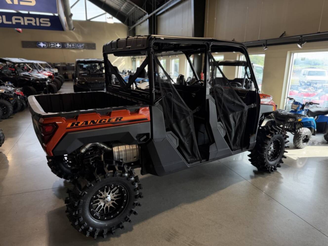 A photo of this 2026 Polaris RGR CREW XP 1000 PREMIUM ORANGE RUST