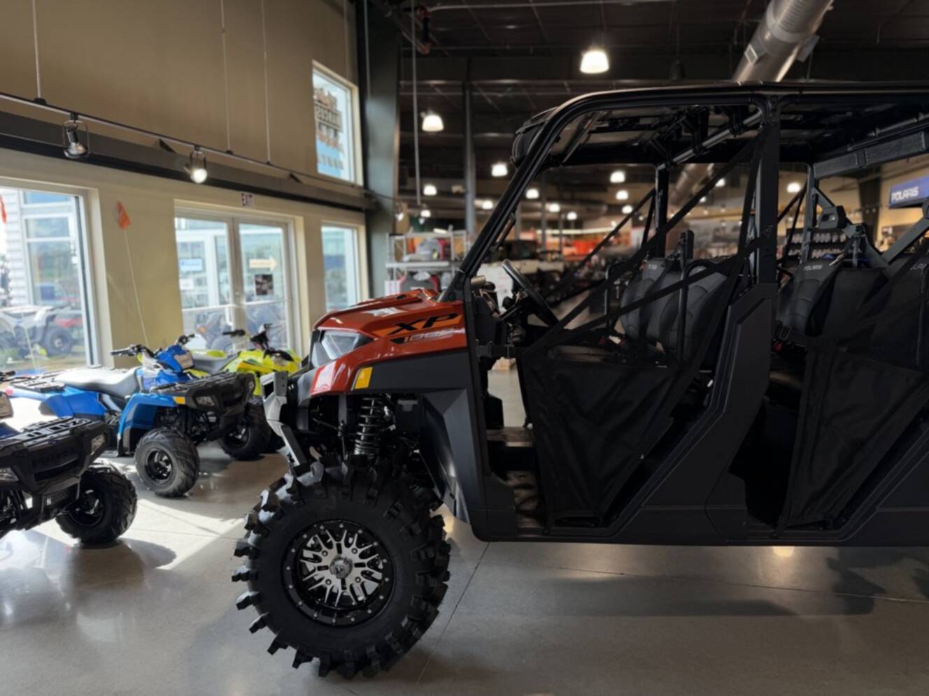 A photo of this 2026 Polaris RGR CREW XP 1000 PREMIUM ORANGE RUST