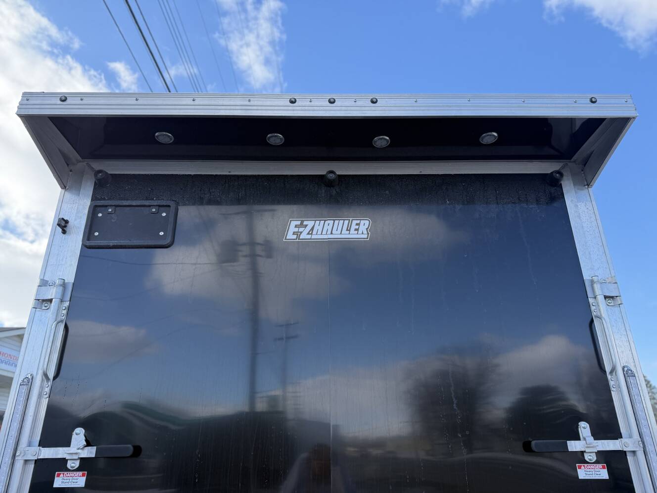 A photo of this 2026 Ez Hauler EZES 7.5X24 Enclosed Snowmobile Trailer