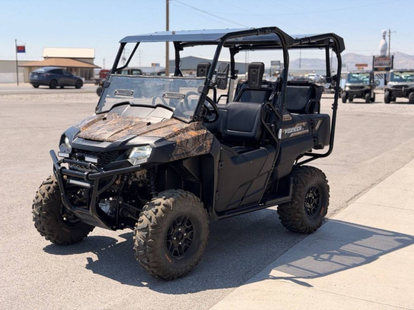 A photo of this 2021 Honda Pioneer 700-4 Deluxe Honda Phantom Camo