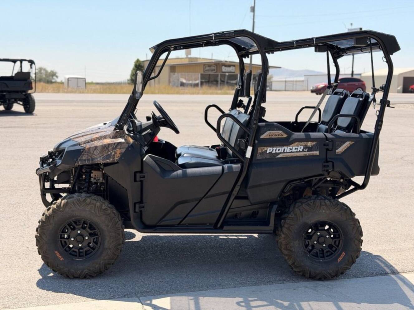 A photo of this 2021 Honda Pioneer 700-4 Deluxe Honda Phantom Camo