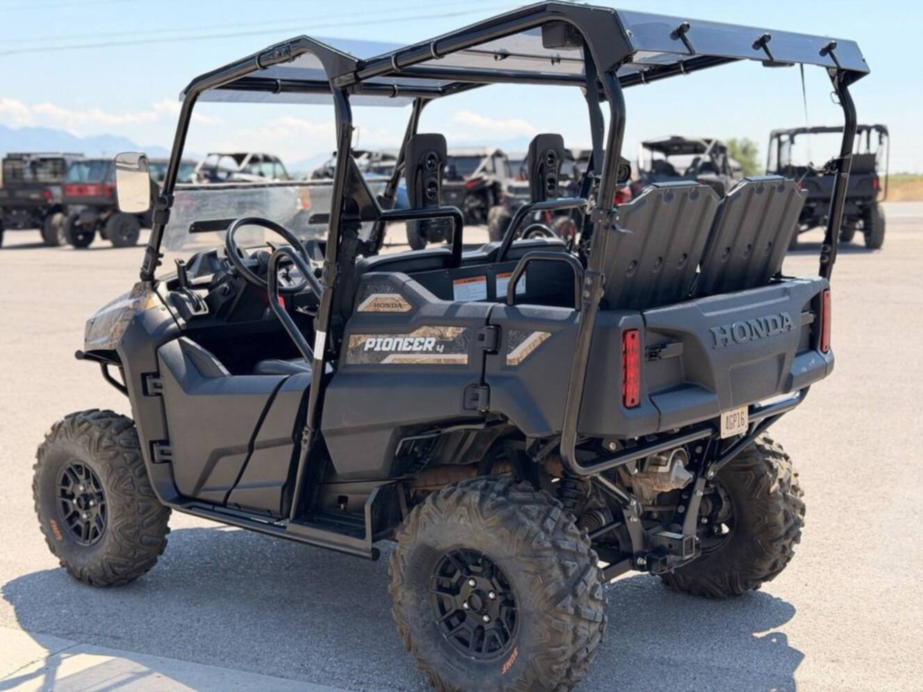 A photo of this 2021 Honda Pioneer 700-4 Deluxe Honda Phantom Camo