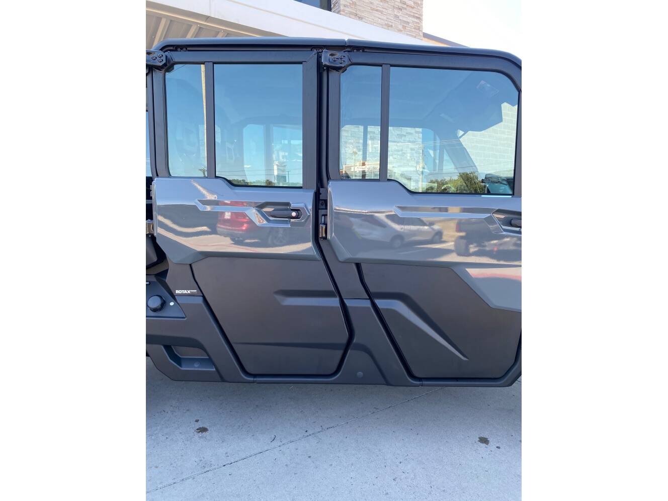 A photo of this 2027 Can-Am Defender MAX DPS CAB HD10 Dolomite Grey