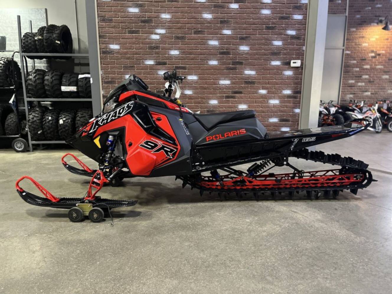 A photo of this 2026 Polaris Patriot 9R RMK Khaos 165 Indy Red / Gloss Black Patriot