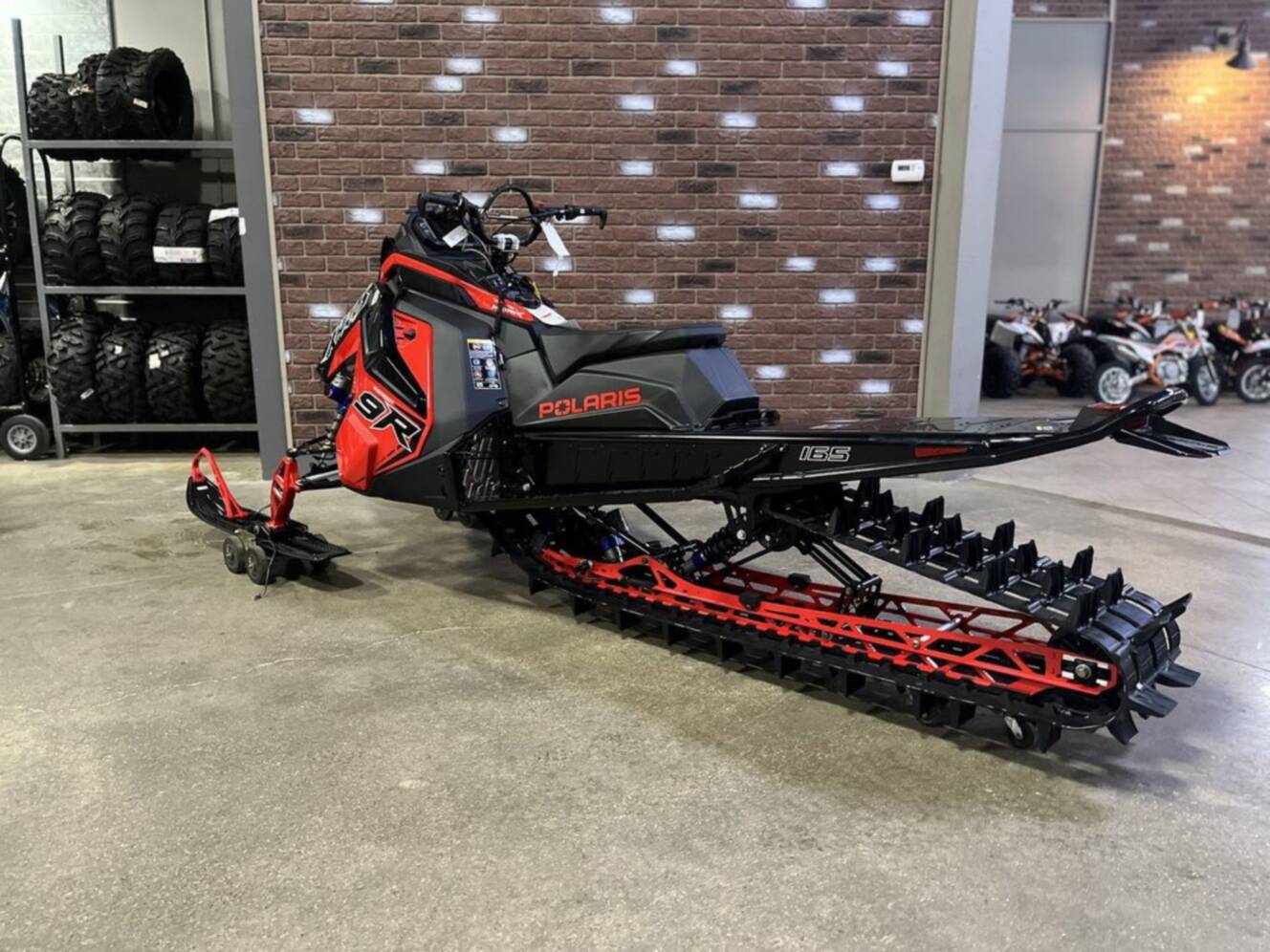 A photo of this 2026 Polaris Patriot 9R RMK Khaos 165 Indy Red / Gloss Black Patriot