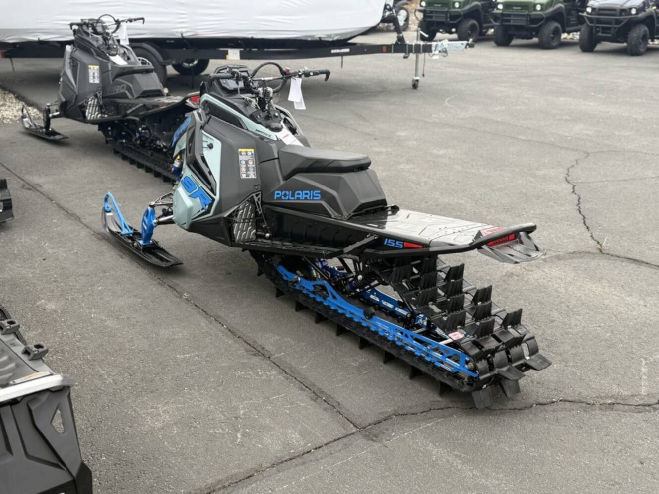 A photo of this 2026 Polaris Patriot 9R RMK Khaos 155 Premium Sagebrush Green Met / 