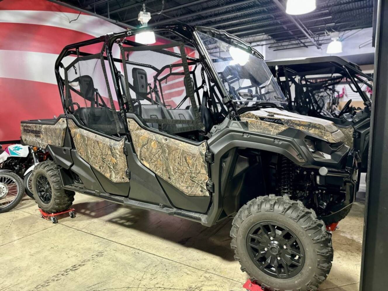A photo of this 2025 Honda® Pioneer 1000-6 Deluxe Crew TrueTimber Atera Camo