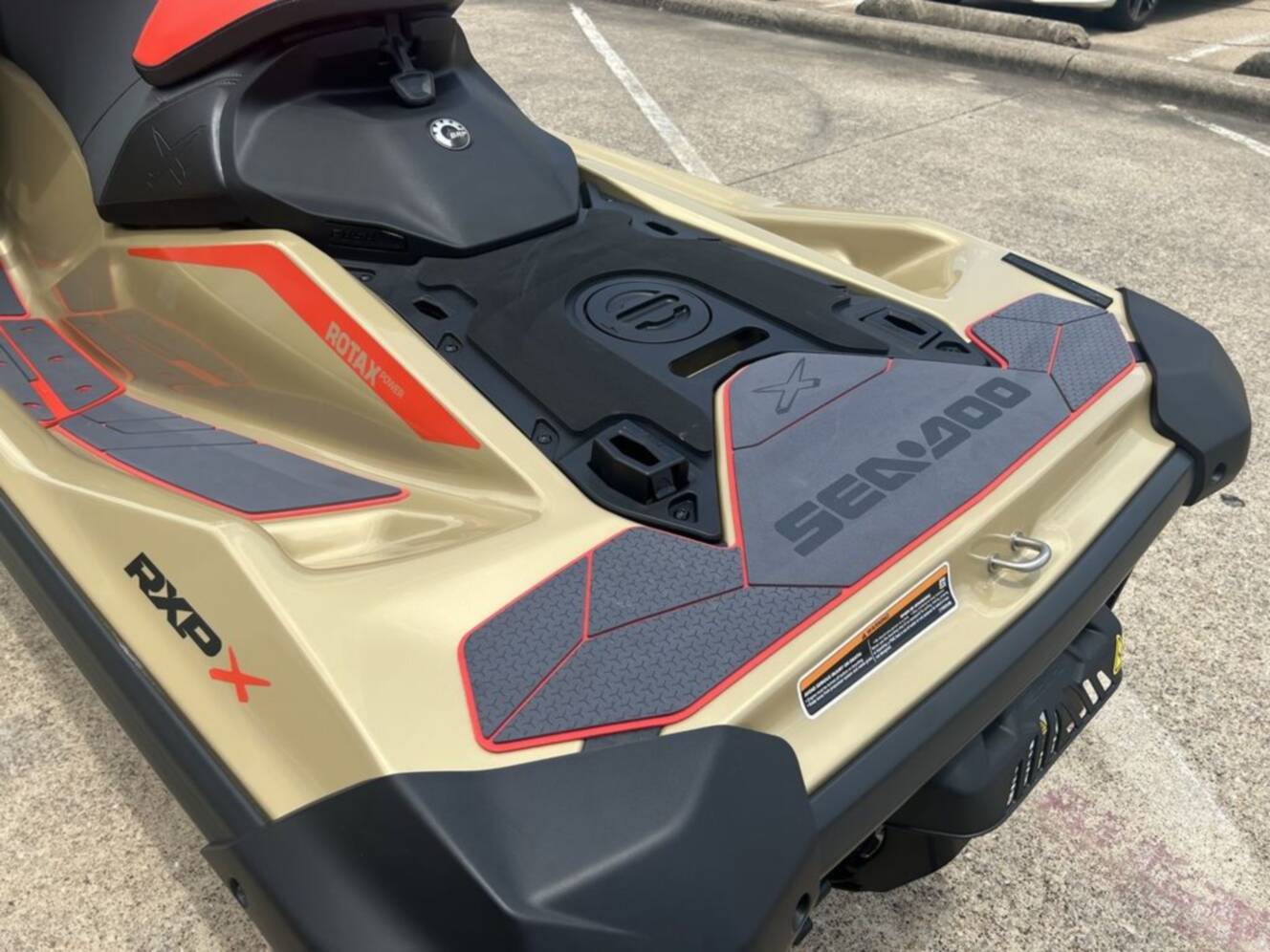 A photo of this 2025 Sea-Doo RXP-X 325 Tech, BRP Premium A, iBR Metallic Tan / La