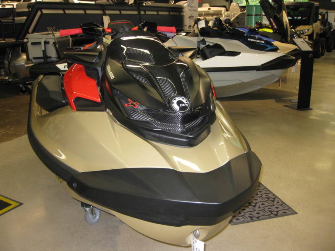 A photo of this 2025 Sea-Doo RXP-X 325 Tech, BRP Premium A, iBR Metallic Tan / La