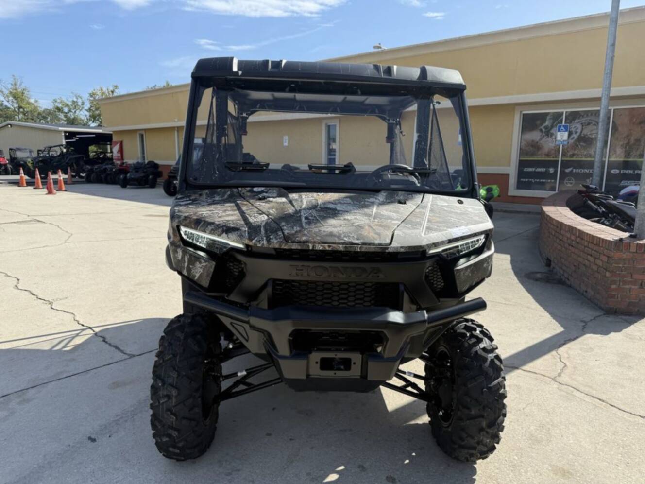 A photo of this 2026 Honda Pioneer 1000-5 Deluxe TrueTimber Atera Camo Deluxe